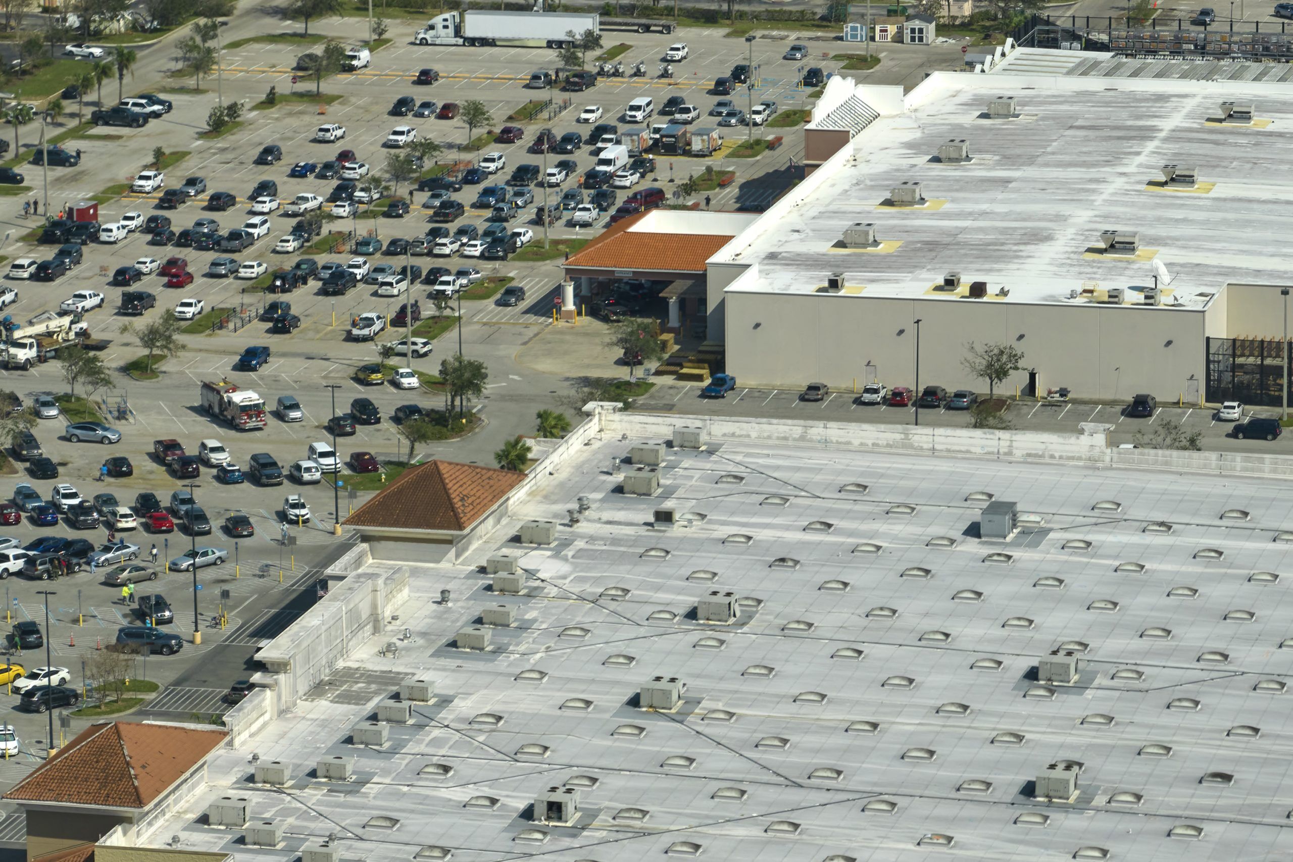 A damaged commercial roof that is leaking internally, prompting the question "how to fix commercial roof leak​s"